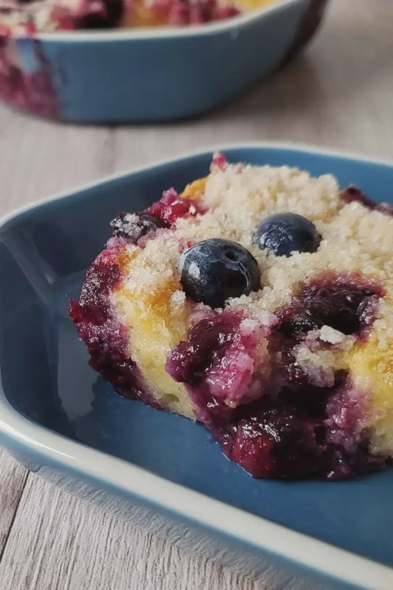 Delicious homemade blueberry pudding cake with fresh blueberries on a wooden table