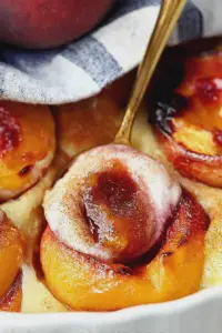 Delicious cinnamon sugar baked peaches served with vanilla ice cream and caramel sauce