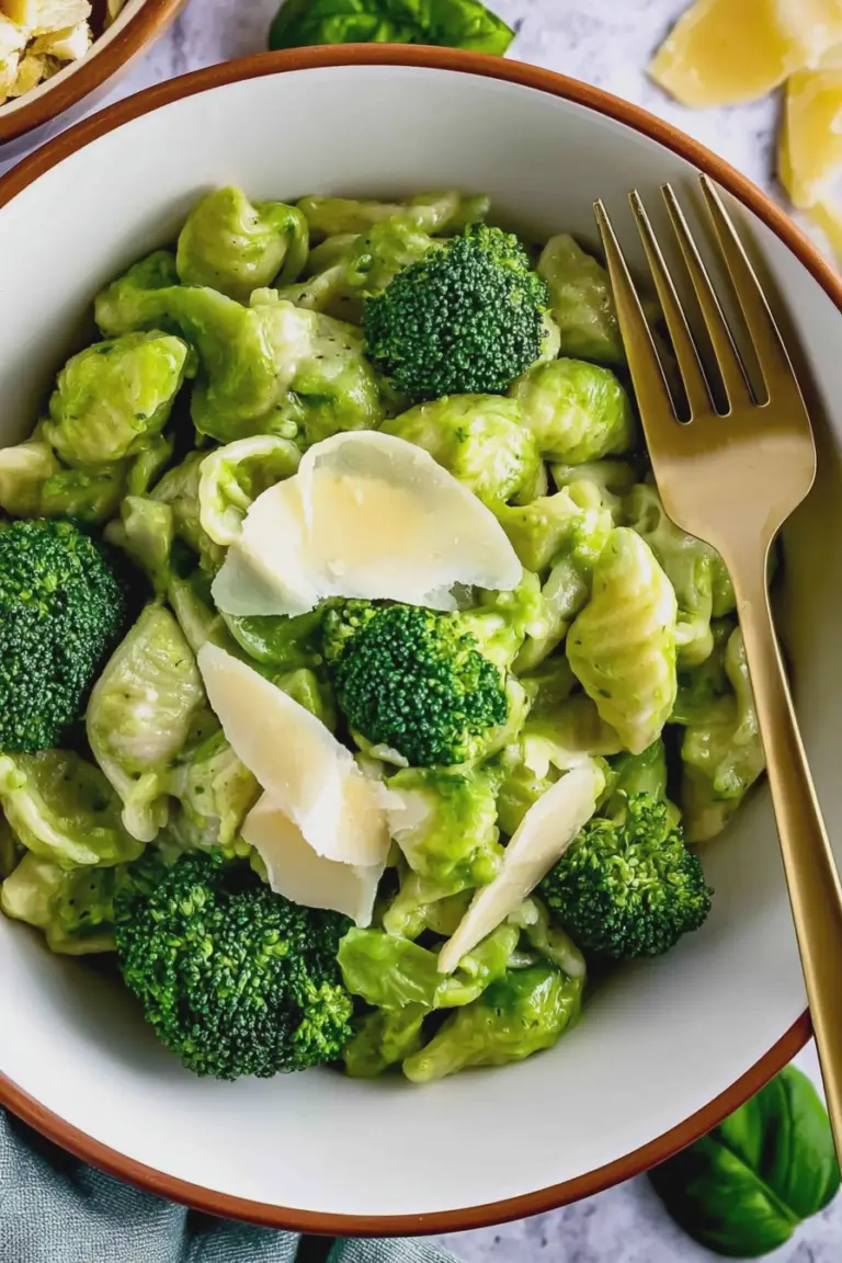 Creamy broccoli pasta garnished with basil and parmesan