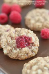 Delicious healthy raspberry oatmeal cookies served with fresh raspberries and a glass of milk.