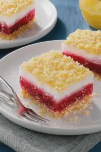 Close-up of a layered rhubarb icebox dessert with fluffy cream and crushed graham cracker crust.