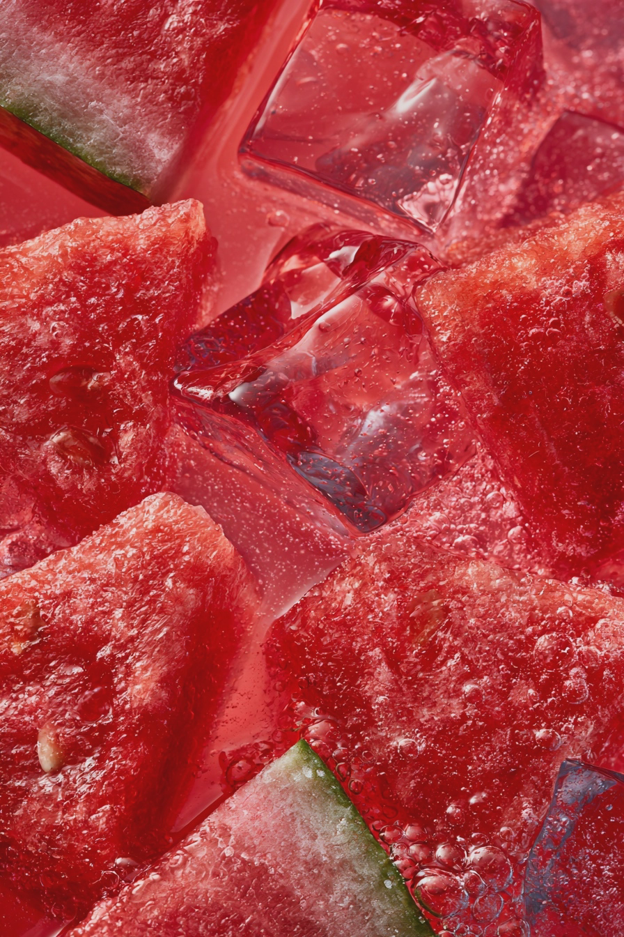 Refreshing watermelon lemonade in a glass with watermelon and lemon garnish, perfect for summer.